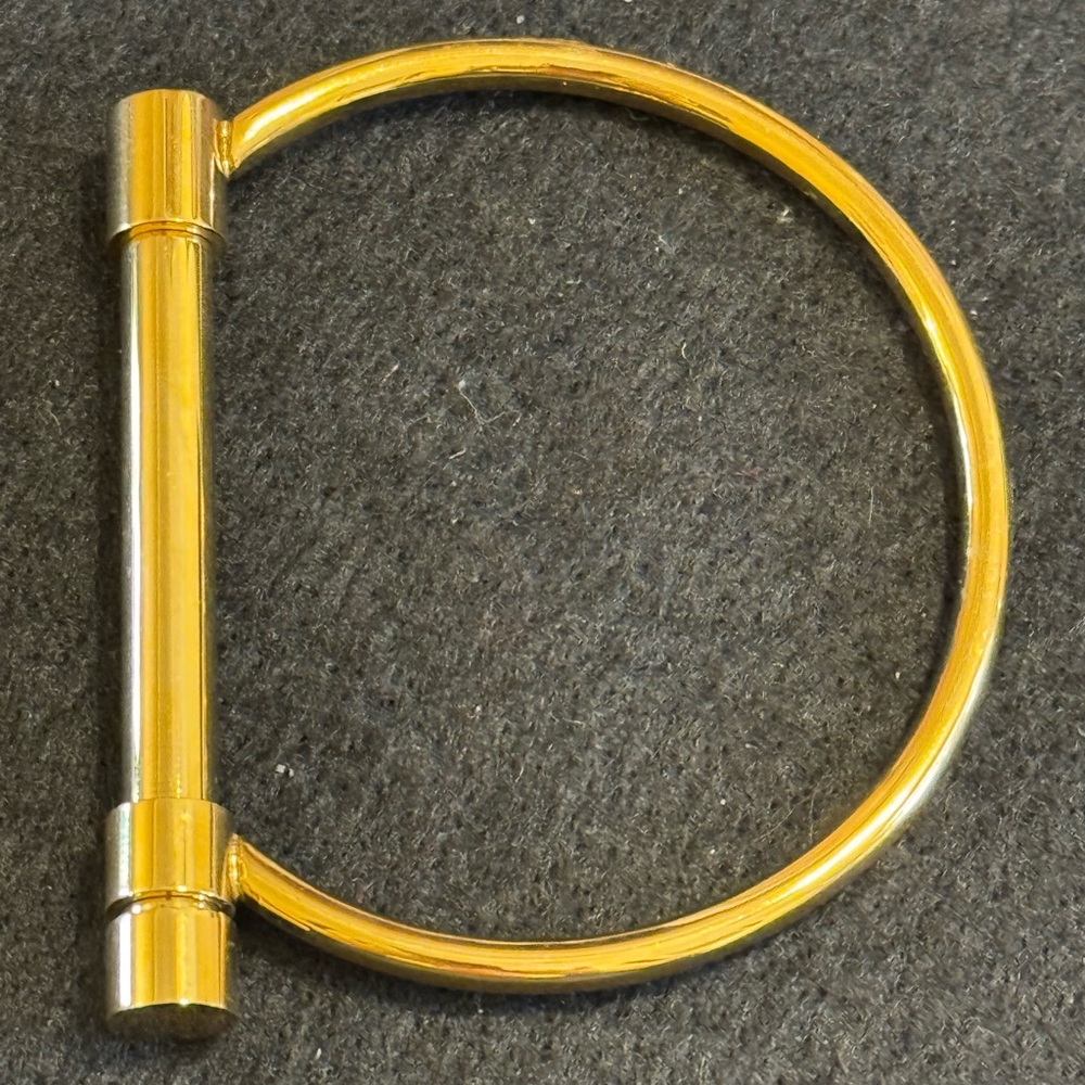 Gold tone D shaped cuff bracelet with screw closure